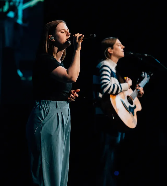 Worship leader singing with a microphone during a church service