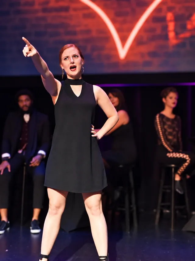 Performer singing an audition piece on stage