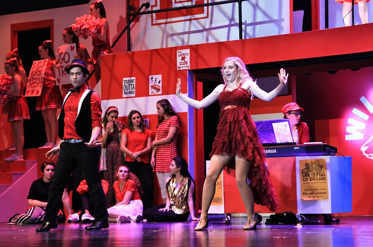 Musical theater performer singing on stage
